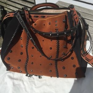 Coach 36 in suede with western whiplash detail.